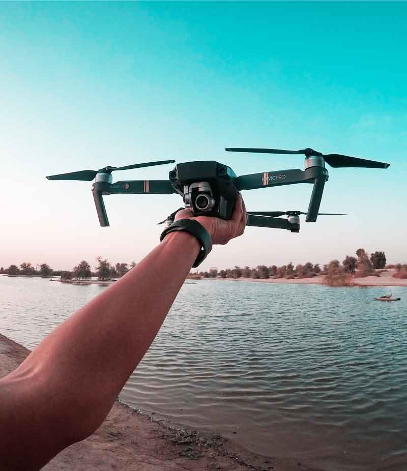 A drone held above the water before a flight