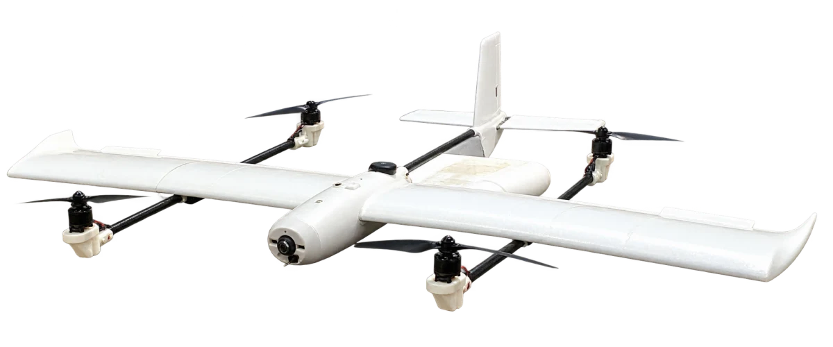 White fixed-wing VTOL aircraft with four lift motors, isolated from the event booth photograph